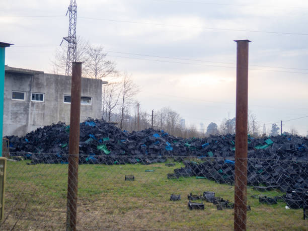 istock Mountains of fruit boxes. Lots of plastic boxes. Waste dump. Collecting plastic. 1481265275