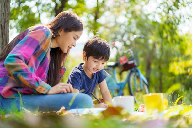 istock Mother and son relaxing at the park. 1481266185