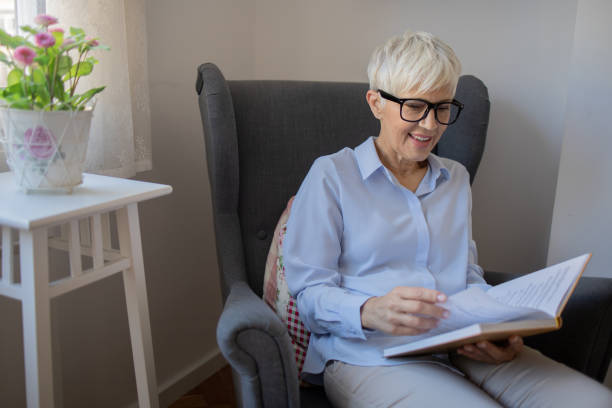 istock Happy woman reading book at home 1481267301