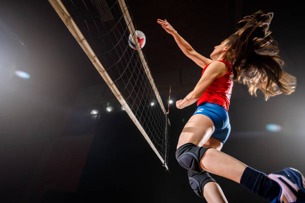 istock Female volleyball player kicking ball through net 1481267568