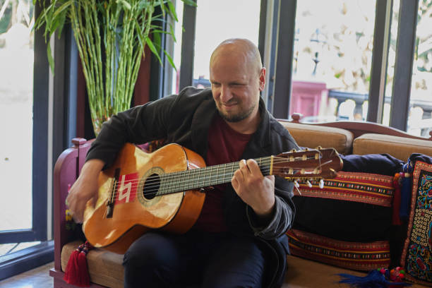 istock Emotional Man Playing Guitar in an Interior Setting 1481267601