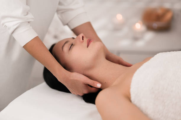 istock Young calm lady relaxing with closed eyes during massage 1481267650