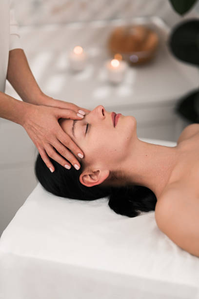 istock Crop anonymous masseuse doing manual face massage to calm female client 1481267663
