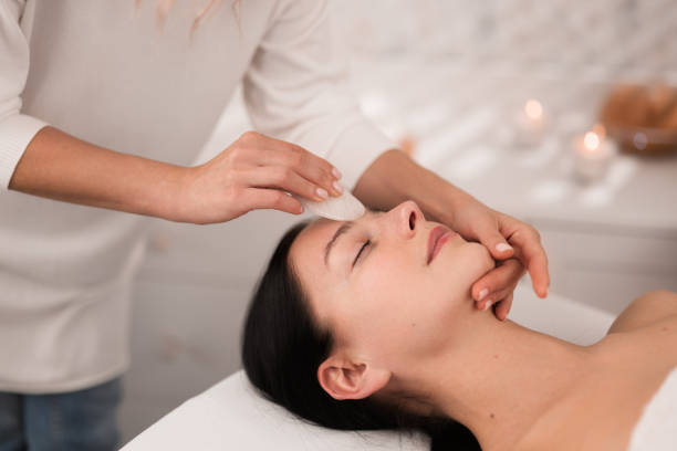 istock Professional massage therapist applying face massage to client 1481267680