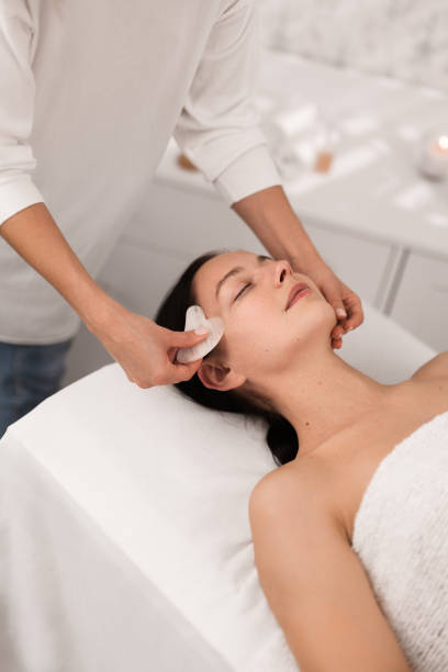 istock Crop professional therapist massaging clients face with gua sha tool 1481267683