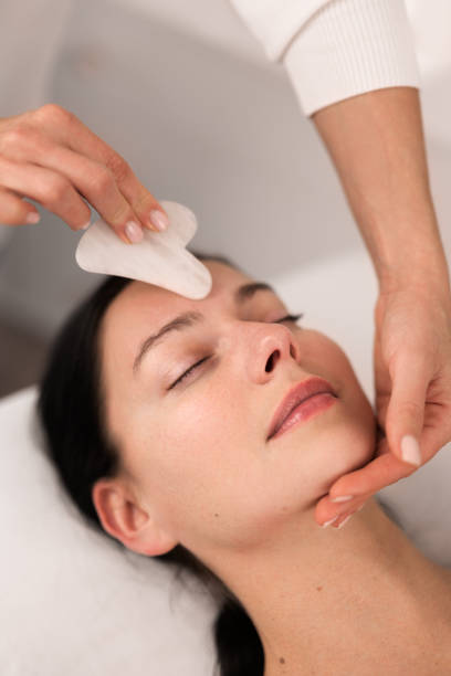 Young woman during Gua Sha Chinese traditional massage