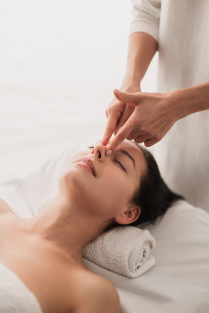 istock Crop masseuse massaging nose of client 1481267714