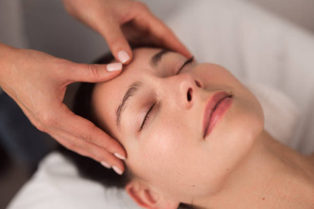 istock Anonymous masseuse doing face massage to relaxed female customer 1481267722