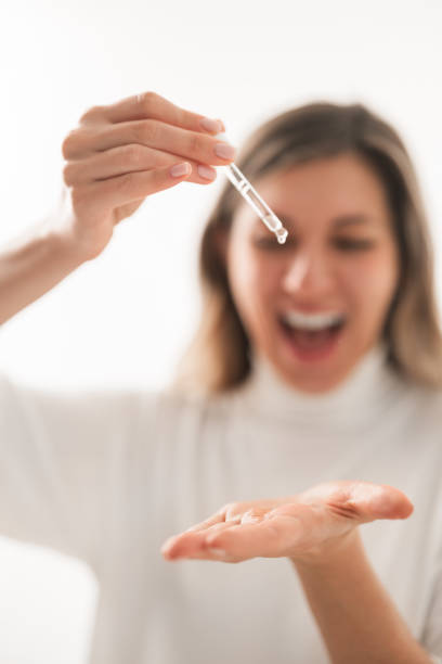 istock Excited woman pouring liquid serum on palm 1481267761