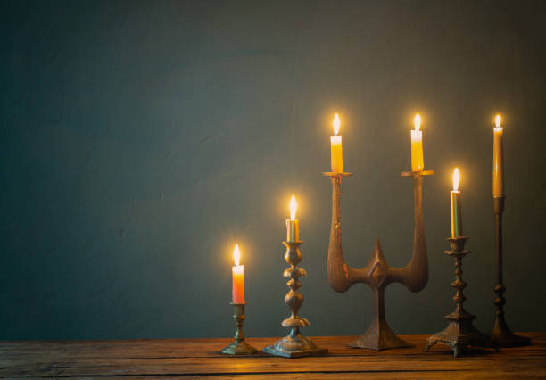 istock burning candles in vintage candlesticks on dark background 1481267867