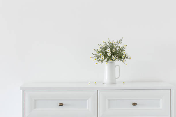 istock white flowers in white ceramic vase in white interior 1481267874