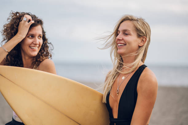 istock Two beautiful woman friends having fun on a beach 1481267913