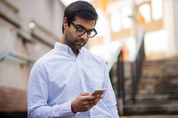 istock Indian Man Texting on his Smart Phone in the City 1481267952