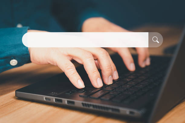 istock Mature man hand working with laptop computer on table in his home. Search the Internet with an empty search bar. Best SEO search networking, Searching browsing internet data information concept. 1481272163