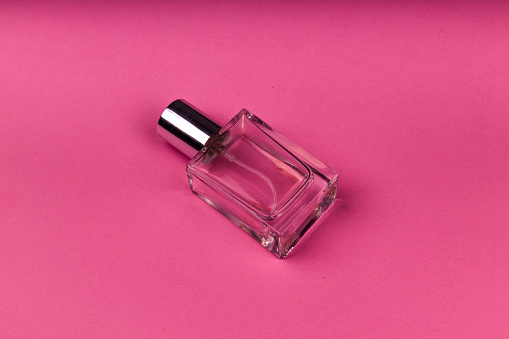 Perfume is held by a persons hand in a store isle