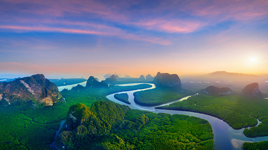 Panorama of Phang Nga bay with mountains at sunset in Thailand.