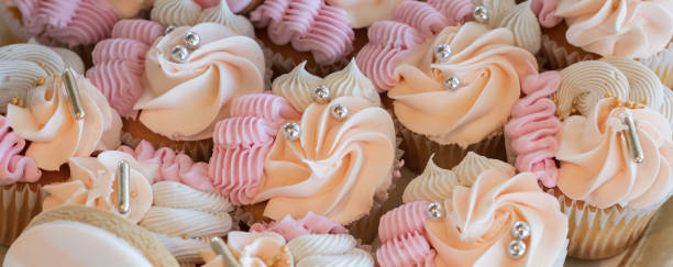 istock Cupcakes with silver sugar pearls, vanilla cupcakes with pink, white and peach cream, selective focus, close up 1481276408