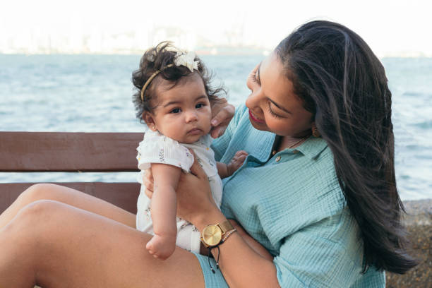 istock Latin Mother And Her Baby On The Beach 1481281006