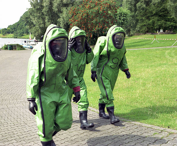 istock A picture of 3 people wearing protective suits 148128187
