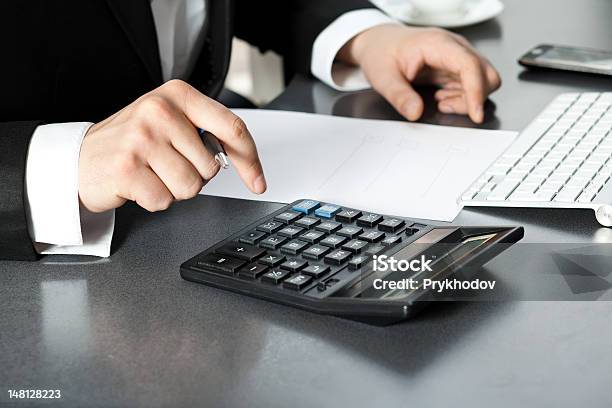 Businessman In Office At The Computer Stock Photo - Download Image Now - Calculator, Desktop PC, Adult