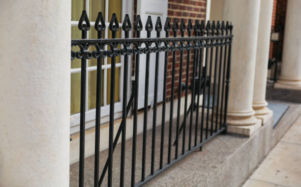 istock metal fence symbolizes protection, security, and confinement. It can represent physical barriers, safety, privacy, or inequality. 1481284885