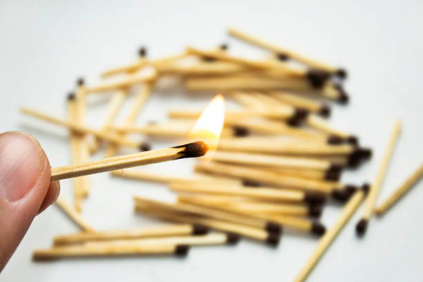 istock A burning match against a background of randomly scattered matches. 1481285699