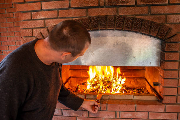 istock man doing barbecue, grilling kebabs on the fire in the oven 1481285756