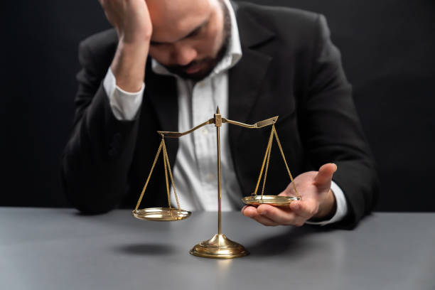 Lawyer or judge in formal black suit hold unbalanced scale . equility stock photo