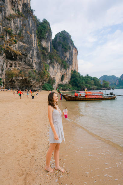 istock Woman drinking smoothie on the beach 1481296525