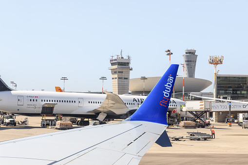 Tel Aviv-Yafo, Israel, 16 March, 2023 : View from the window of a Flydubai aircraft moving along the runway to the standing planes of world airlines and the airport building at Ben Gurion Airport in Israel