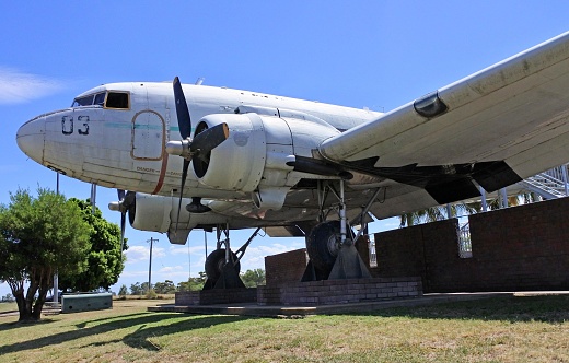 Douglas Dakota DC3 aircraft at airshow showing propellers and fuselage from the rear with some shadow areas