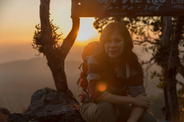 Asian woman backpacker on mountain peak