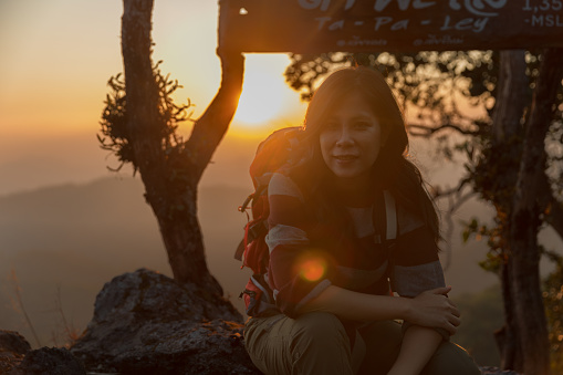 Asian woman backpacker on mountain peak