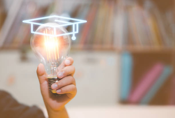 istock educational concept, girls hand holding a light bulb and graduated hat 1481299306