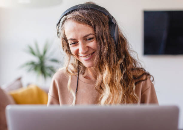 istock Woman in headphones communicates by video call 1481305553