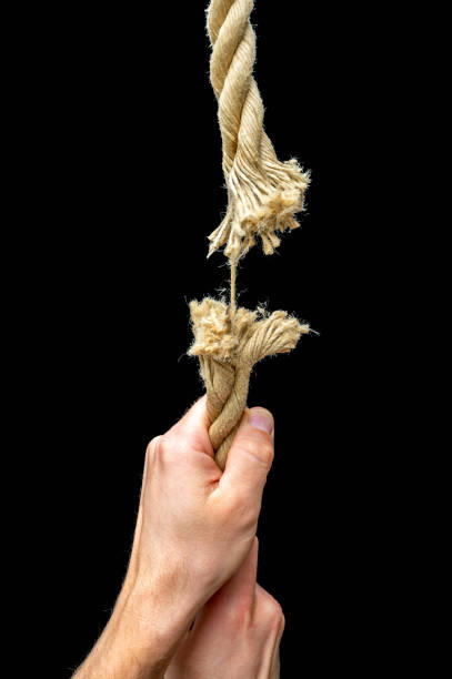 istock Man holds on to tearing rope 1481307134