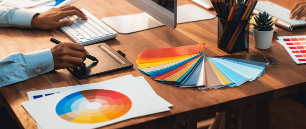 Graphic designer works on computer laptop with digital pen. Scrutinize