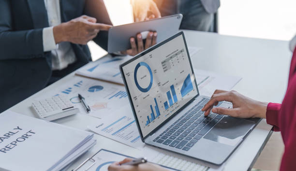 istock Business People Meeting using laptop computer,calculator,notebook,stock market chart paper for analysis Plans to improve quality next month. Conference Discussion Corporate Concept. 1481308466