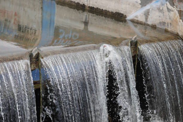 istock Water flowing through a sluice on a concrete man made river 1481308574
