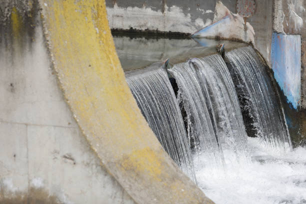 istock Water flowing through a sluice on a concrete man made river 1481308578