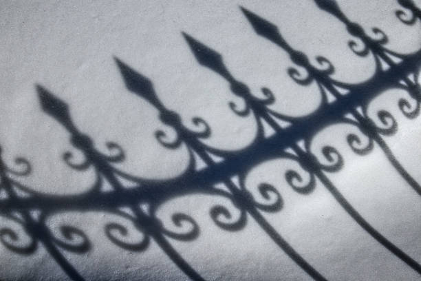 cast iron fence shadow on the snow