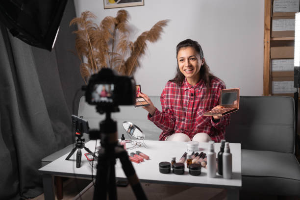 istock Young woman make up artist, professional beauty vlogger or blogger recording makeup tutorial for website or social media. Business online influencer on social media 1481309324