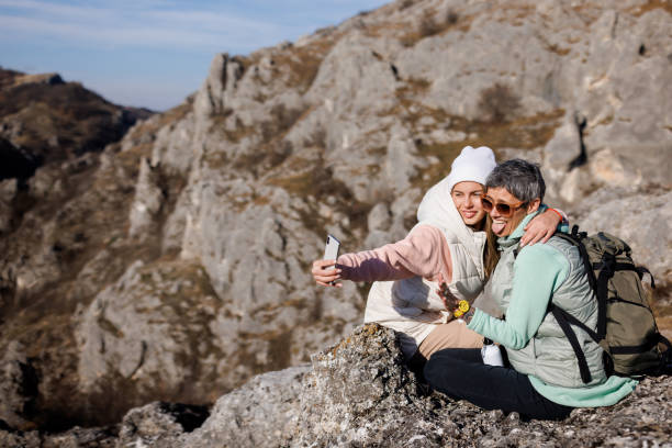 istock Mother and daughter taking selfie while hiking in rocky mountain 1481311174