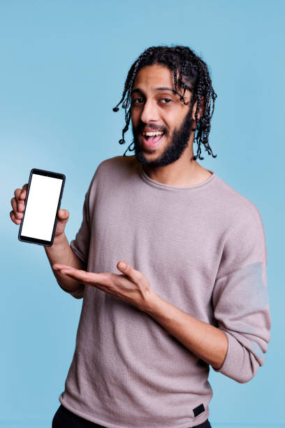 istock Happy arab advertiser holding smartphone with blank white screen 1481312346