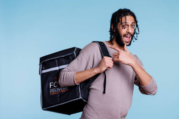 istock Happy arab restaurant courier pointing at thermal backpack portrait 1481312508