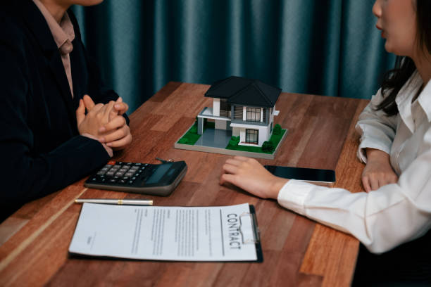 istock Reviewing house loan contract with agent using calculator. Enthusiastic 1481312737
