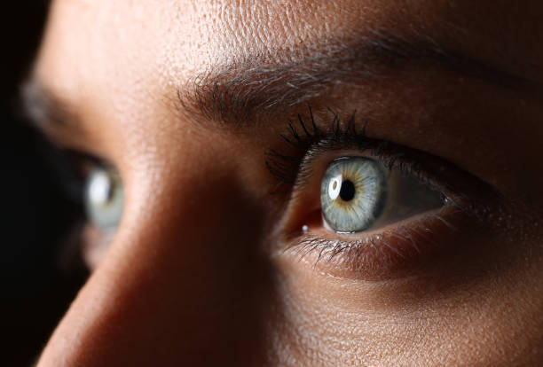 Amazing female green colored eyes in low light technique Amazing female green and blue colored eyes in low light technique close-up visual sense stock pictures, royalty-free photos & images