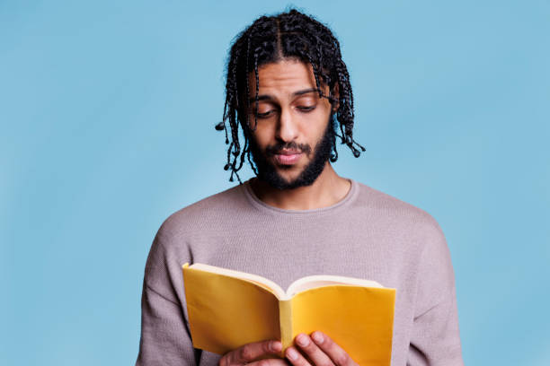 istock Serious concentrated arab man reading book and thinking 1481313482