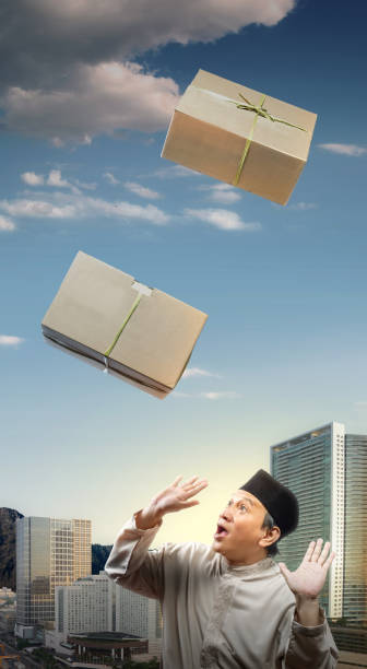 istock Asian Muslim man afraid of dropping box 1481313921