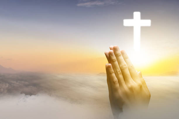 istock Human hand praying with Christian cross 1481315200